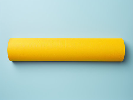 Rolled yellow yoga mat isolated on blue background. 3d illustrationの写真素材