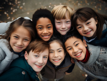 Top view of group of smiling children looking at camera on blurred backgroundの素材