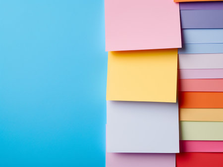 Colorful sticky notes on blue background. Top view with copy spaceの写真素材