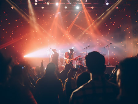 Silhouettes of concert crowd on the stage during a live concertの写真素材