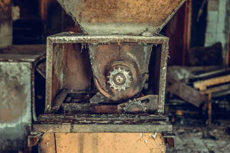 Destroyed and abandoned factory shop, complete mess and desolation. Remains of equipment and...