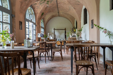Charming Vintage Cafe Interior Featuring Beautiful Wooden Tablesの写真素材