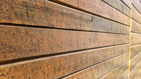 Close-up of aged wooden planks showing rich textures and color variation, ideal for rustic and vintage-themed backgrounds.の写真素材