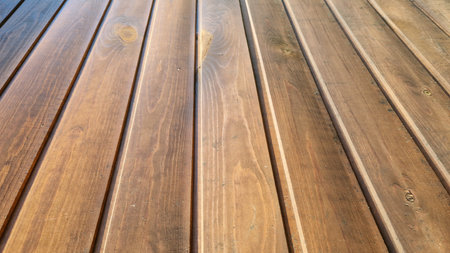 Textured surface of rustic wooden planks, highlighting the natural patterns and grain, suitable for textured backgrounds.の写真素材