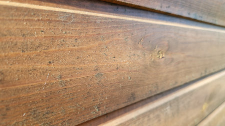 Close-up of weathered wooden planks showing detailed textures and natural color variations, suitable for rustic backdrops.の写真素材