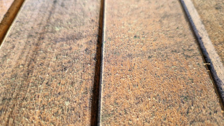 Natural light enhances the rich textures and weathered look of wooden planks, showing the beauty of aged materials.の写真素材