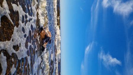 Ocean Waves Crashing on Coastal Bouldersの写真素材