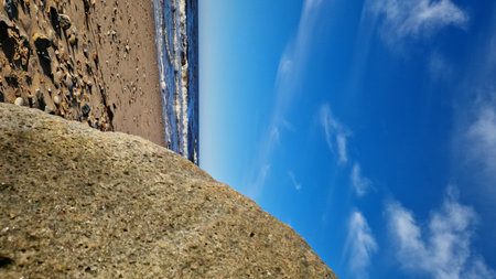 Sunny Seaside with Boulder and Blue Skyの写真素材