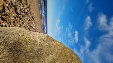 Sunny Coastal View with Granite Boulder and Wavesの写真素材