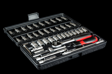 Set of socket wrench in plastic box isolated on black backgroundの写真素材