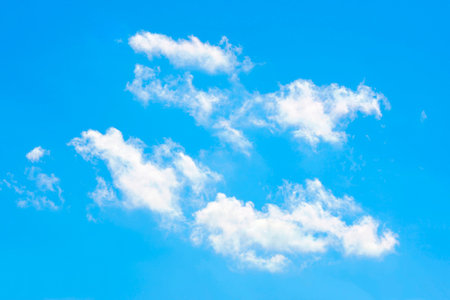Four twain clouds in lucid blue sky.