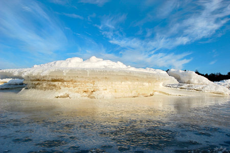 icy coastline with bright blue sky in sunny morning