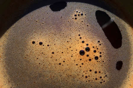 Surface of freshly made coffee in cup, fragment.の写真素材