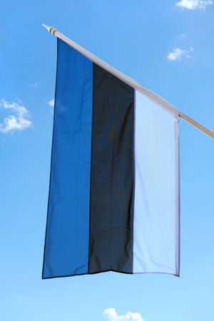 Estonian flag against blue sky on Estonian Independence Day.の写真素材