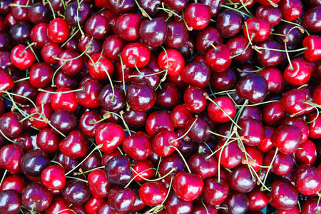 Ripe shiny heart cherries background.