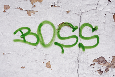 Text "boss" on the wall of an abandoned building.の写真素材