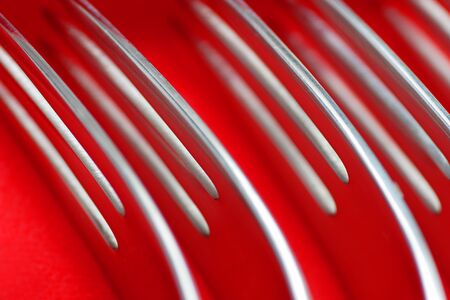 Closeup fragment of forks and spoons in design package, selectively focused.の写真素材