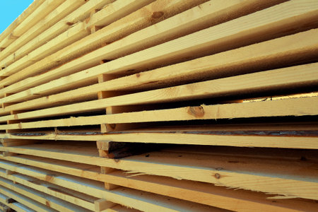 Freshly cut boards heaped up for open-air drying.