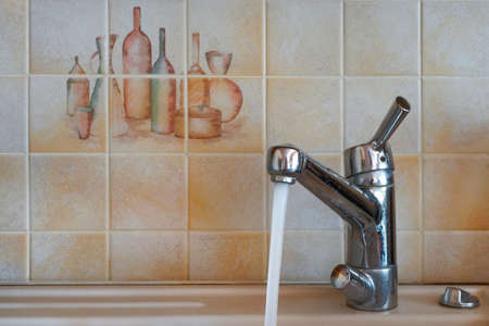 Water tap covered with water stains  left running.の写真素材