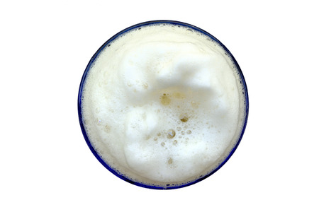 Froth in a glass of light beer. View from above, isolated on white.の写真素材