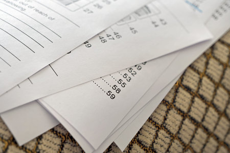 Printed sheets of paper from an online manual on sofa, very shallow depth of field, focused on...