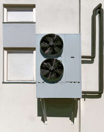 Robust old  industrial air conditioner mounted on wall.の写真素材