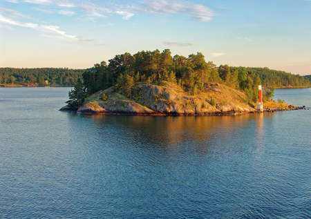 Tiny rocky island in summer evening light in Stockholm archipelago.の写真素材