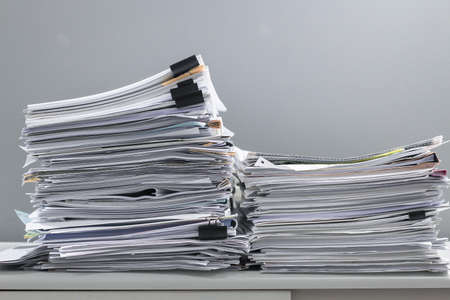 Pile of papers on the deskの写真素材