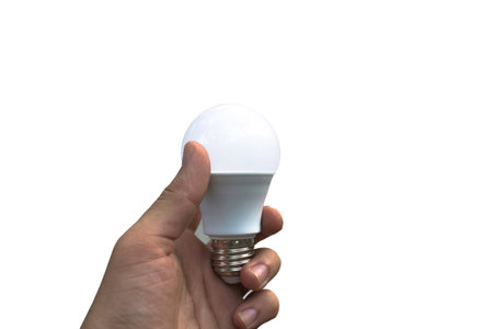 Hand holding LED light bulb isolated on white background