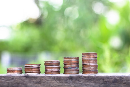 silver coin stack in business growth concept on wood table with green nature background.