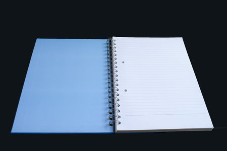 open blue book on a black background 