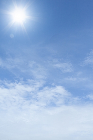 Blue sky with clouds and sun の写真素材