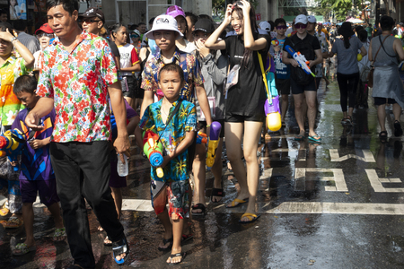 BANGKOK, THAILAND - APRIL 14, 2019: people playing water in Songkran festival on April 14, 2019 at Silom Road in Bangkokのeditorial素材