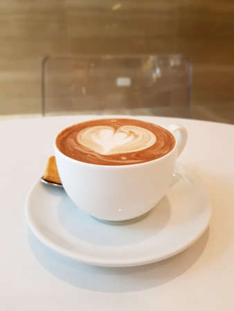 A cup of creamy hot latte in the afternoonの写真素材