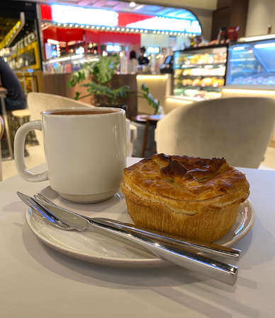 Freshly baked chicken mushroom pie and hot chocolate for breakfast. Cosy ambience. Warm toned lighting.の写真素材