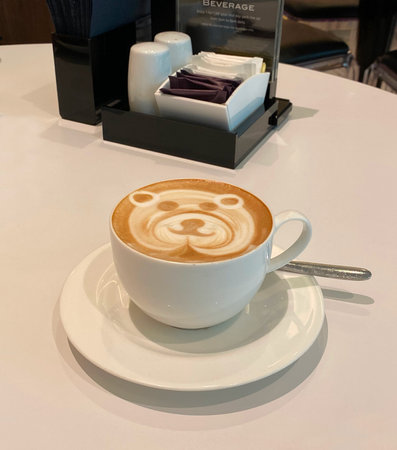 A cup of hot latte with cute bear latte art.の写真素材
