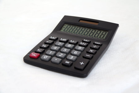 Black calculator on white background. It is something used for making mathematical calculations, in...