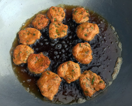 Fish cake in the pan. it is a fish that has been formed into small flat, round shapes, and cooked in...