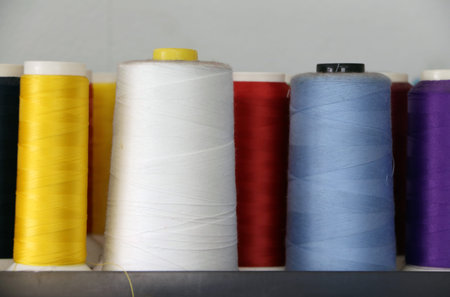 Colorful thread in the thread roll, white color, blue, red, yellow and purple. Through the use...