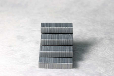 metal staples put to staircase shaped on the white fabric floor. concept of the way to success.の写真素材