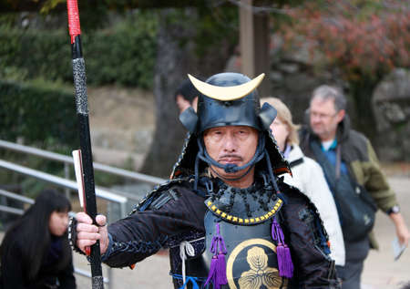 Himeji, Hyogo, Kansai, Japan November 19, 2017: Man in Samurai Dress, Tourist Can be take a photo to keep a memorial at Himeji Castle. Samurai is a member of a powerful military caste in feudal Japan, especially a member of the class of military retainersのeditorial素材