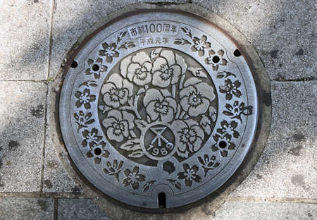 Nakagyo, Kyoto, Japan, November 17, 2017 : The Beauty flower pattern of Japanâs Manhole Cover on the sidewalk. (Japanese: 100 year memorial of Heisei) The Heisei period is the current era in Japan. It started on January 1989.のeditorial素材