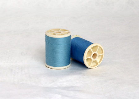 Couple thread tube with blue and light blue isolate on white background. Its is a garment...