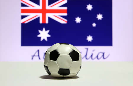Small football on the white floor and Australian nation flag with the text of Australia background. The concept of sport.の写真素材