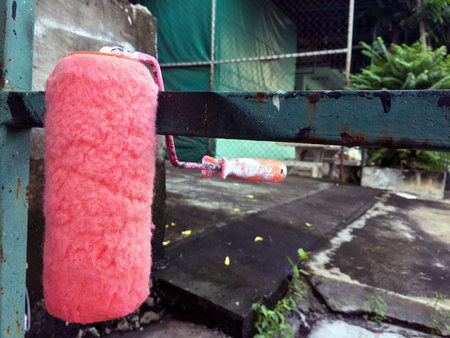 Roller for painting, After paint the pink color. cleaning and dried on the green metal core.の写真素材