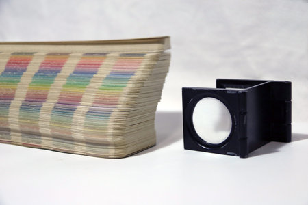 Black square Magnifying glass and Rainbow Sample Colors Palette Catalog, Color swatches book isolated on White Background.の写真素材