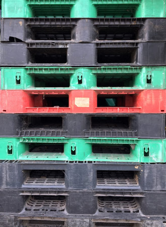 The layer of Pallet, made from Plastic and wood. It is black, green, red, blue and brown color.
