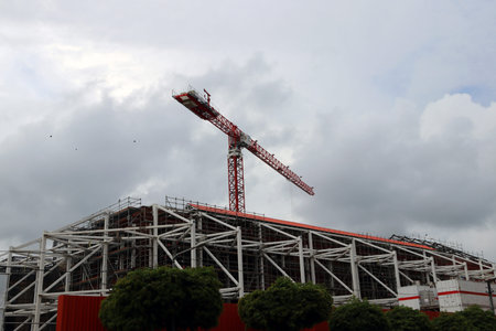 Big crane above the construction of building on cloud and sky background. crane is a large, tall...