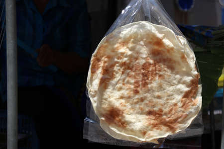 Kite cracker in the clear plastic bags hanging for sale, it is Thai cornflakes dessert.の写真素材