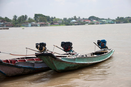 Three wooden boat machine landing on the water in the river. it is a small vessel propelled on water by an engine.の写真素材